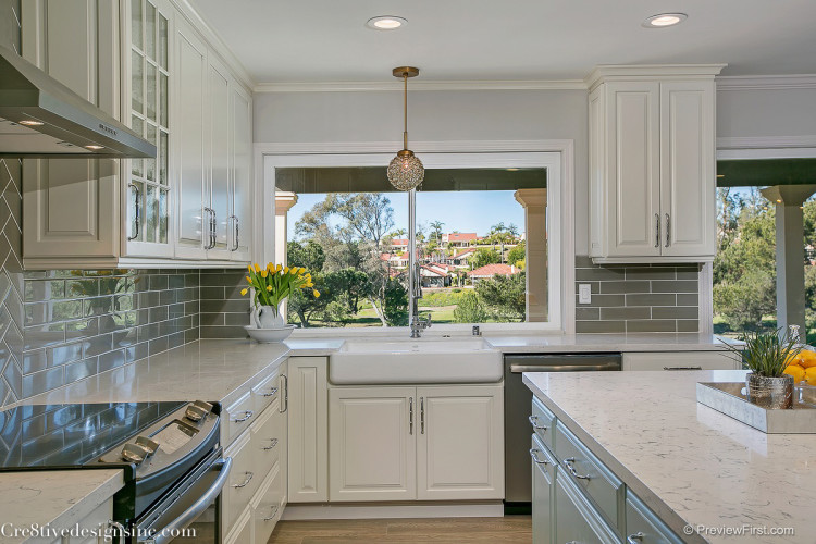 Ivory shaker cabinets and gray backsplash